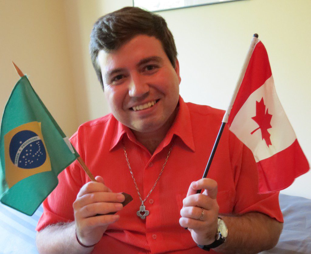 Fr. Willyans Prado Rapozo, SCJ with the flag of his homeland of Brazil and his new home of Canada.