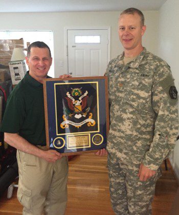 Fr. Mark receives a farewell gift from his battalion