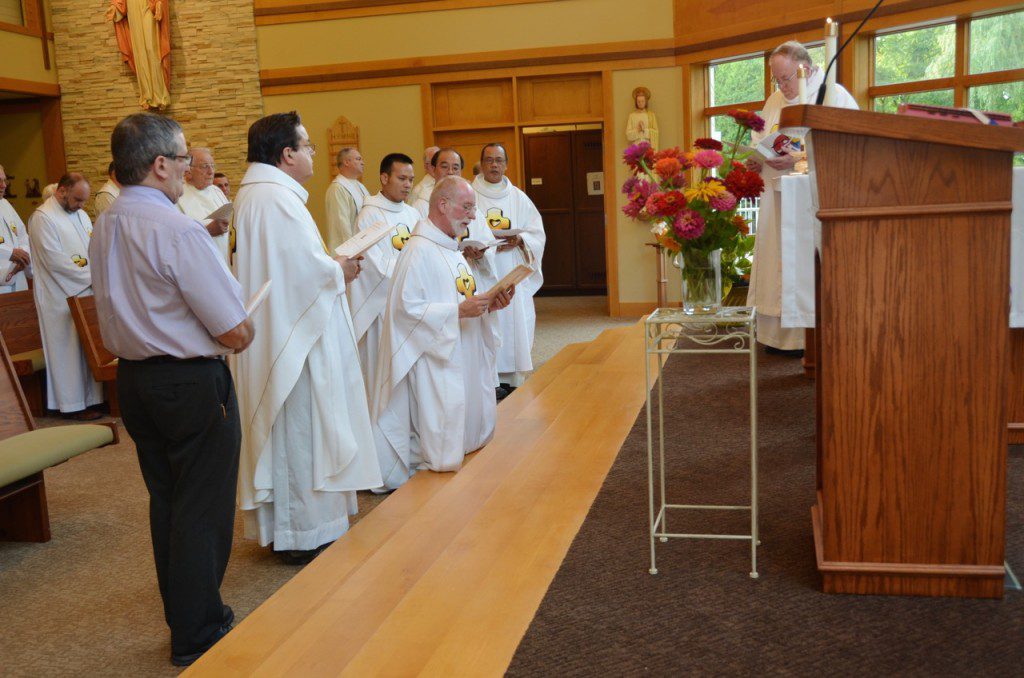 Fr. Ed professes his oath of fidelity while the council looks on during last Thursday's installation. 