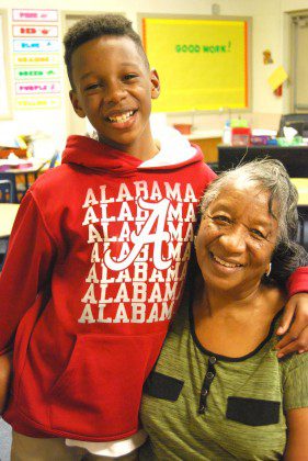 Mrs. Rayford and her grandson. A teacher at Holy Name School in Holly Springs, her newly remodeled home was severely damaged by December storms.