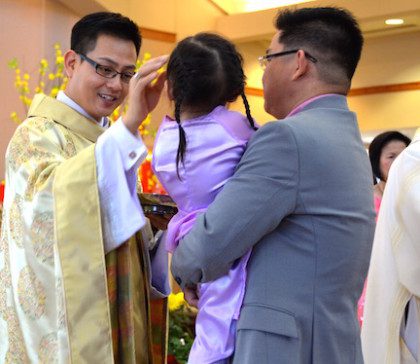 Fr. Joseph blesses a family