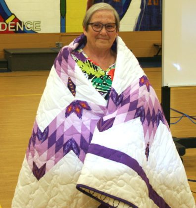 Mary Jane wrapped in a Native American quilt that she was given to honor her years at St. Joseph's
