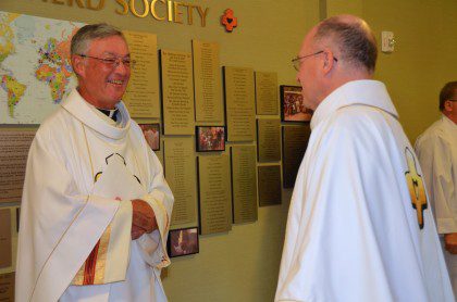 Fr. Tom Cassidy and Fr. Stephen Huffstetter share a smile before the installation.
