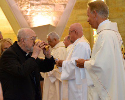 Fr. Jim Schroeder shares the Eucharist with retired Archbishop Rembert Weakland