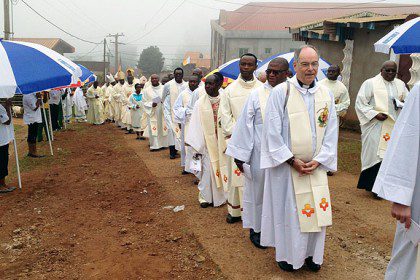 Fr. Charles Brown (front of line), Fr. Byron Haaland and Fr. Jan de Jong represented the US Province at the blessing of the new Church of the Sacred Heart in Cameroon.
