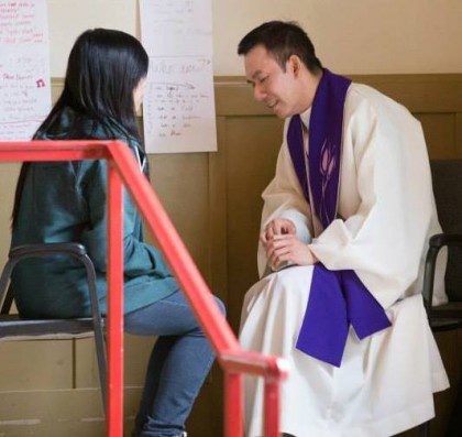 Fr. Vien hears a confession during youth ministry