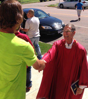 Fr. Guy greets a parishioner after Mass