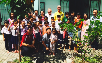 Fr. Tom (yellow shirt, back) and Fr. Rino at Huong Tam