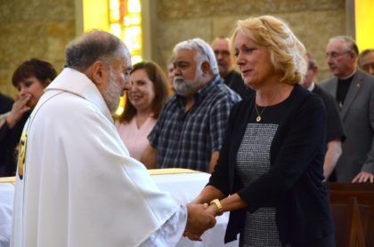 Fr. Tony greets Fr. Peter's family 