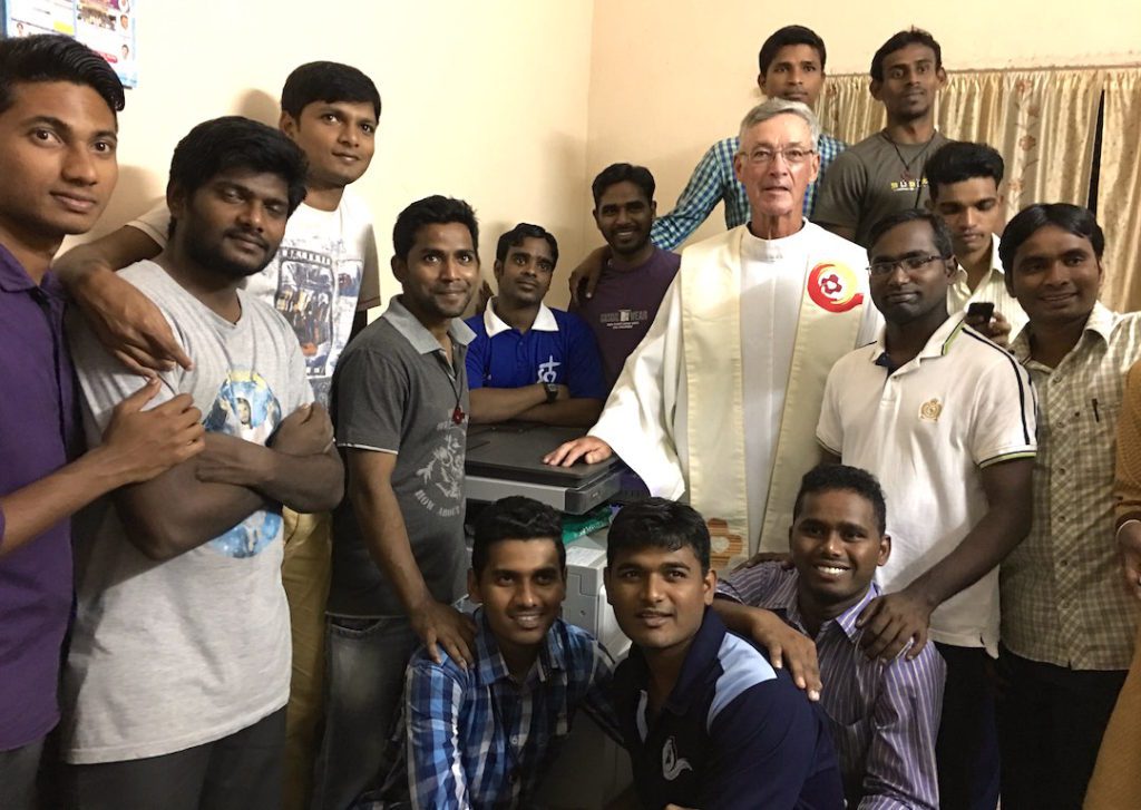 Fr. Tom and students with the newly blessed machine